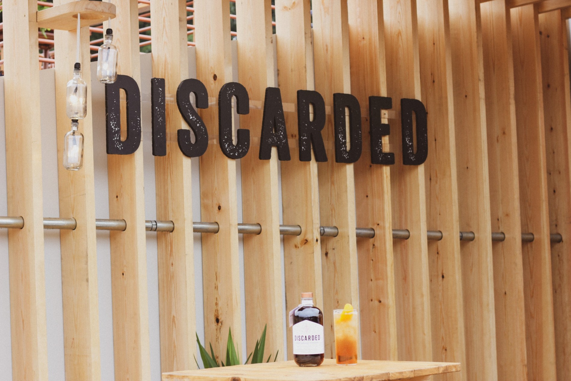 Discarded Wooden Sign with Discarded bottles